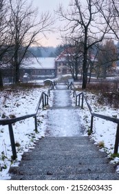 Bischofsheim, Germany - November 9, 2019: Icy stairs leading down the mountain to Kreuzberg monastery on a cold, snowy day in Bavaria, Germany.