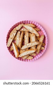 Biscotti with nuts on pink background. Delicious cantucci cookies. Cantuccini. Traditional italian homemade dry crispy biscuits.