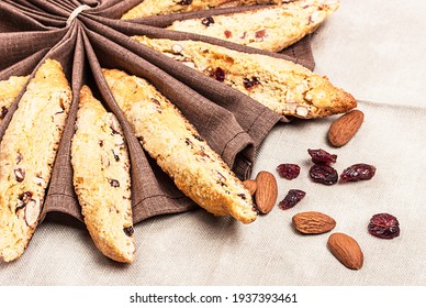 Biscotti on a brown fabric with raisins and nuts