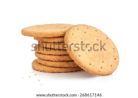 BISCUITS - A stack of delicious wheat round biscuits with a few crumbs isolated on white