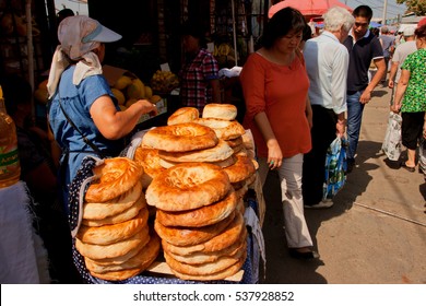 BISHKEK, KYRGYZSTAN - AUG 1: Vendors Selling Traditional Central Asian Bread On The Popular Osh Market On August 1, 2013. In Kyrgyzstan 34 Perc. Are Under Age Of 15 And 6.2 Perc. Are Over 65.