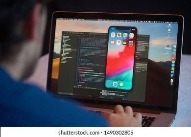 Bishkek, Kyrgyzstan - January 17, 2019: Man developer launches xcode software and ios simulator program to develop ios app on a MacBook