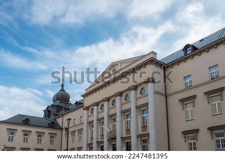 Bishop's palace in Katowice, Silesia, Poland. Front facade of neoclassicist building build in 1927–1933. Frontal 
colonnade, decorative cornice and window framing detail. Big, metal dome helmet. 