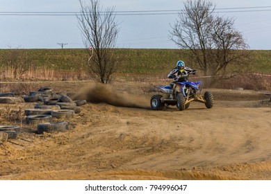 Biskupice Radlowskie, Poland - January 14, 2018: ATV rider creates a large cloud of dust and debris on day.