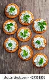 Bisquit Cracker Appetizers With Cottage Chees And Parsley Topping