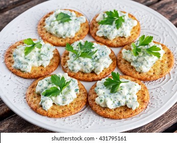 Bisquit Cracker Appetizers With Cottage Chees And Parsley Topping