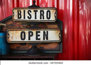 Bistro And Open Sign On Red Wall Background 