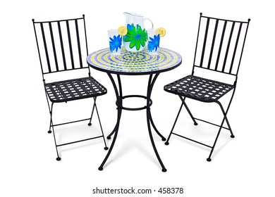 Bistro Table And Chairs Over White With Pitcher Of Lemonade And Two Glasses.