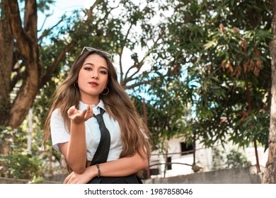 A bitchy and demanding young woman, asking for money or daring someone. A manipulative person. Outdoor scene.