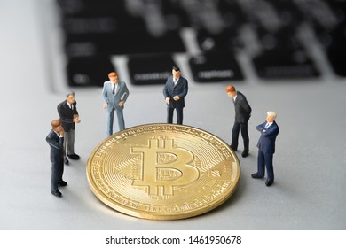 Bitcoin (BTC) Coin And Businessmans On Notebook. Digital Cyber Safety Or Security Encryption. Manage Bitcoin Price Schedule Concept. Money Laundering Bitcoin Concept. Market Manipulation.