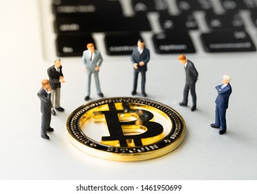 Bitcoin (BTC) Coin And Businessmans On Notebook. Digital Cyber Safety Or Security Encryption. Manage Bitcoin Price Schedule Concept. Money Laundering Bitcoin Concept. Market Manipulation.