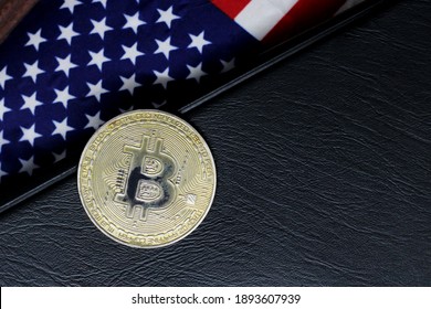 BITCOIN (BTC) cryptocurrency; coin bitcoin on the background of the flag of United States of America (USA)