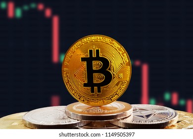 Bitcoin BTC on stack of cryptocurrencies with falling crashing graph in background. The cryptocurrency coin is golden and in focus. This is a price concept of Bitcoin down market.