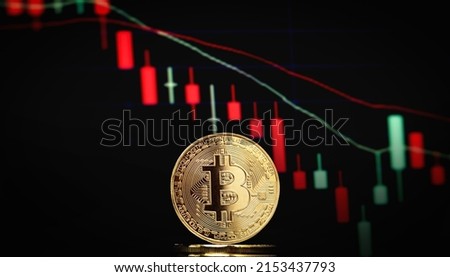 Bitcoin BTC representation coin and the concept of trading stock markets at the blurred background.