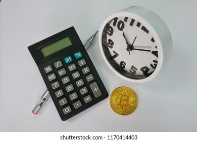 Bitcoin, clock and calculator. Cryptocurrency time tax return concept. copy space.