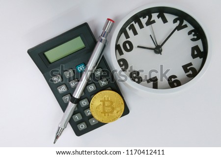 Bitcoin, clock and calculator. Cryptocurrency time tax return concept. copy space.
