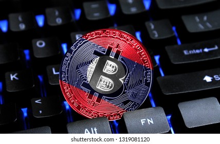 Bitcoin close-up on keyboard background, the flag of Laos is shown on bitcoin.