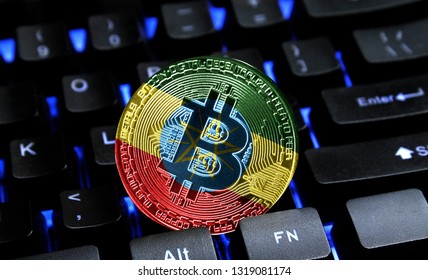 Bitcoin close-up on keyboard background, the flag of Ethiopia is shown on bitcoin.