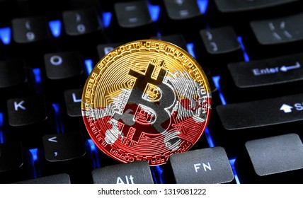 Bitcoin close-up on keyboard background, the flag of Butane is shown on bitcoin.