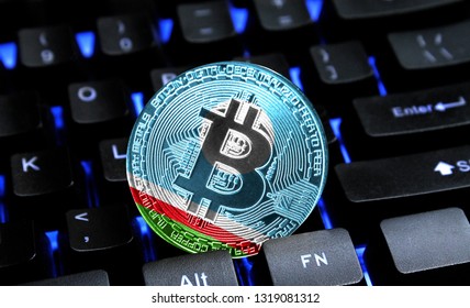 Bitcoin close-up on keyboard background, the flag of Sakha Republic is shown on bitcoin.