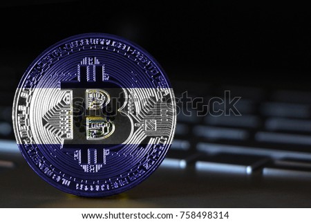 Bitcoin close-up on keyboard background, the flag of El Salvador is shown on bitcoin.