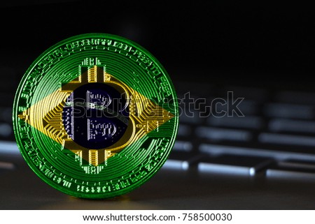 Bitcoin close-up on keyboard background, the flag of Brazil is shown on bitcoin.
