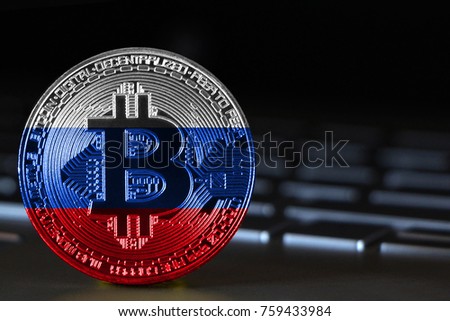 Bitcoin close-up on keyboard background, the flag of russia is shown on bitcoin.