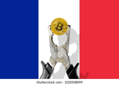 BITCOIN coin being squeezed in vice on the France flag background; concept of cryptocurrency bitcoin under pressure. Prohibition of cryptocurrencies, regulations, restrictions or security