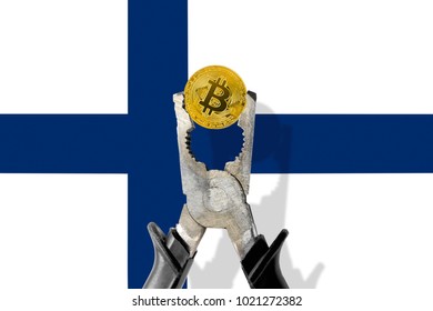 BITCOIN coin being squeezed in vice on the FINLAND flag background; concept of cryptocurrency bitcoin under pressure. Prohibition of cryptocurrencies, regulations, restrictions or security