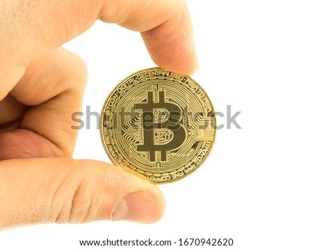 Bitcoin coin in a man's hand on a white background