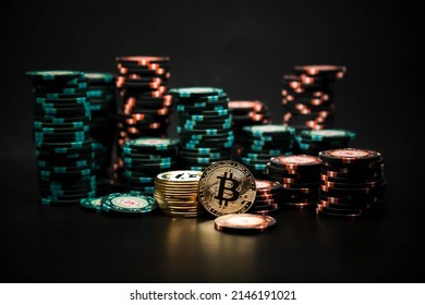 Bitcoin Coins On The Background Of A Slide Of Casino Chips On A Black Background. Bitcoin Casino Game. Cryptocurrency Excitement. Bet On Bitcoins.