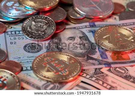 Bitcoin Coins on top of US Dollar Banknotes and Dollar coins in the background. Fiat currency and Digital Blockchain Money. BTC and USD