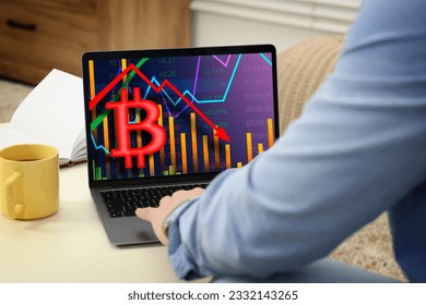 Bitcoin collapse. Trader checking cryptocurrency rates on laptop at home, closeup - Shutterstock ID 2332143265