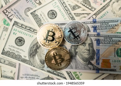 Bitcoin Crypto currency with US Dollar banknotes. Crypto Coins and 100 Dollar Bills. Digital currency on top of fiat money