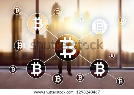 Bitcoin cryptocurrency and blockchain technology concept on blurred skyscrapers background.