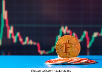 Bitcoin Cryptocurrency. BTC Coins Against The Background Of A Colorful Graph Showing The Rise And Fall Of The Digital Currency. Blockchain Technology