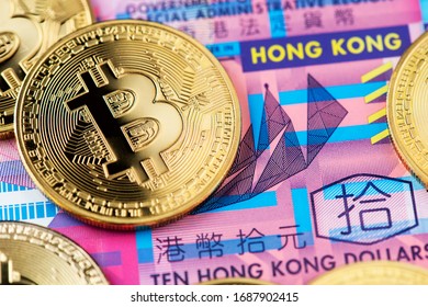 Bitcoin Cryptocurrency coins on Hong Kong Dollar banknotes. 