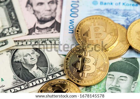 Bitcoin Cryptocurrency coins on US Dollar and South Korea Won currency banknotes. Bitcoin Cryptocurrency concept. Asia BTC Bitcoin cryptocurrency USA  Dollar USD South Korea Won KRW