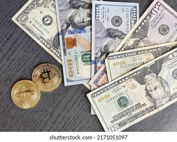 Bitcoin cryptocurrency coins and US Dollar bills. BTC to USD exchange rate.
