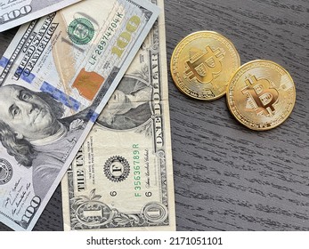 Bitcoin cryptocurrency coins and US Dollar bills. BTC to USD exchange rate.