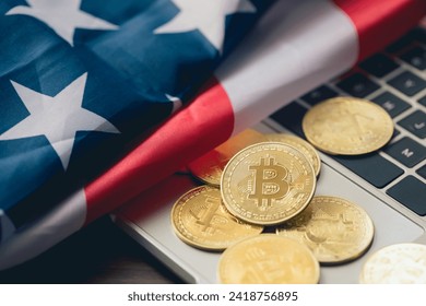 Bitcoin and cryptocurrency investing concept. Bitcoin cryptocurrency coins on a laptop with the United States of America flag. Trading on the cryptocurrency exchange. Bitcoin BTC Cryptocurrency Coins.