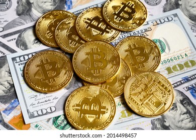 Bitcoin with dollar cash, virtual crypto currency bitcoin (btc) and banknotes. Gold bit coins on US dollar bills pile. Concept of bitcoin payment, digital money, finance, online business and stock. 