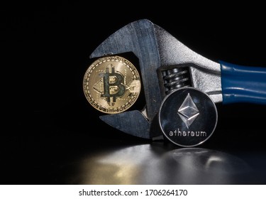 Bitcoin And Ethereum On The Reflective Desk, Closeup. Cryptocurrency Virtual Money. Exchange, Anonymous. Bitcoin Is An Open Source Web Cash Currency. Black Background.