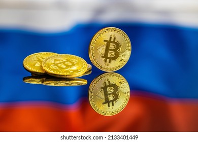 Bitcoin In Front Of Russian Flag. Digital Cryptocurrency. The Russian Flag Background.