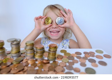 bitcoin glasses, stacks of euro currency coins, small child, blonde girl 3 years old holds bitcoin crypto currency coins in hands, financial literacy of children, Electronic decentralized money