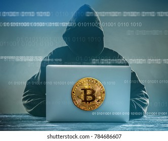 Bitcoin Gold Coin And Anonymous Hacker Sittign With Laptop. Virtual Danger Of Cryptocurrency.