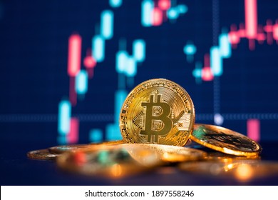 Bitcoin gold coin and defocused chart background. Virtual cryptocurrency concept. - Shutterstock ID 1897558246