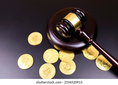 Bitcoin Gold coins and judge gavel on black background
