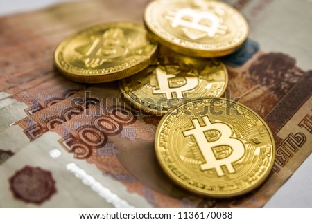 bitcoin gold and the Russian ruble. Bitcoin coin on the background of Russian rubles.