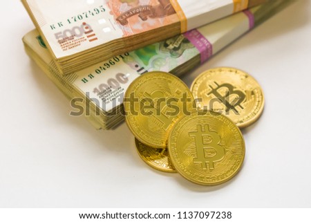 bitcoin gold and the Russian ruble. Bitcoin coin on the background of Russian rubles.